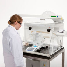 Analyst weighing potent powders in a ST1 powder weighing enclosure